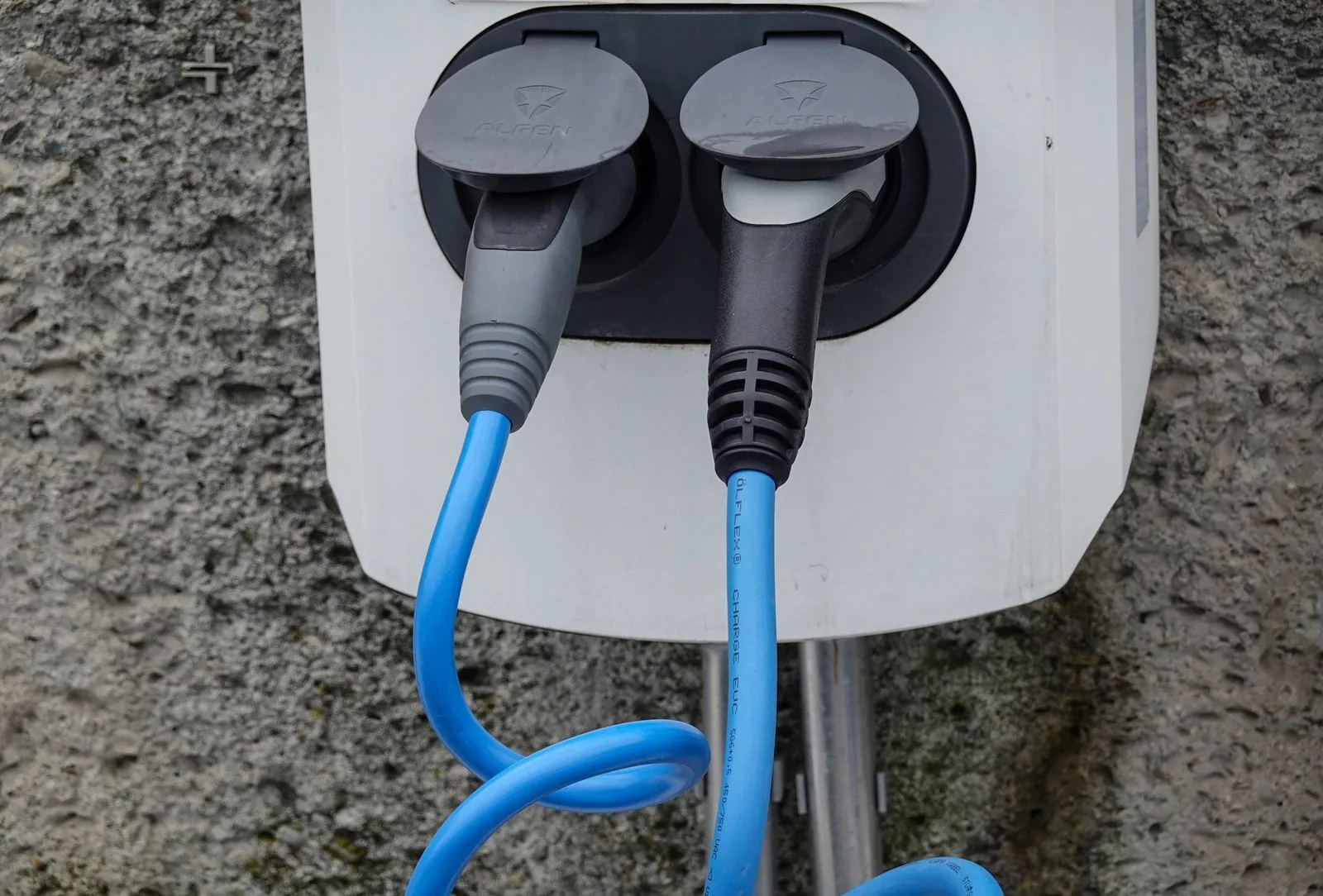 Charging connectors and cables on a wall-mounted EV unit