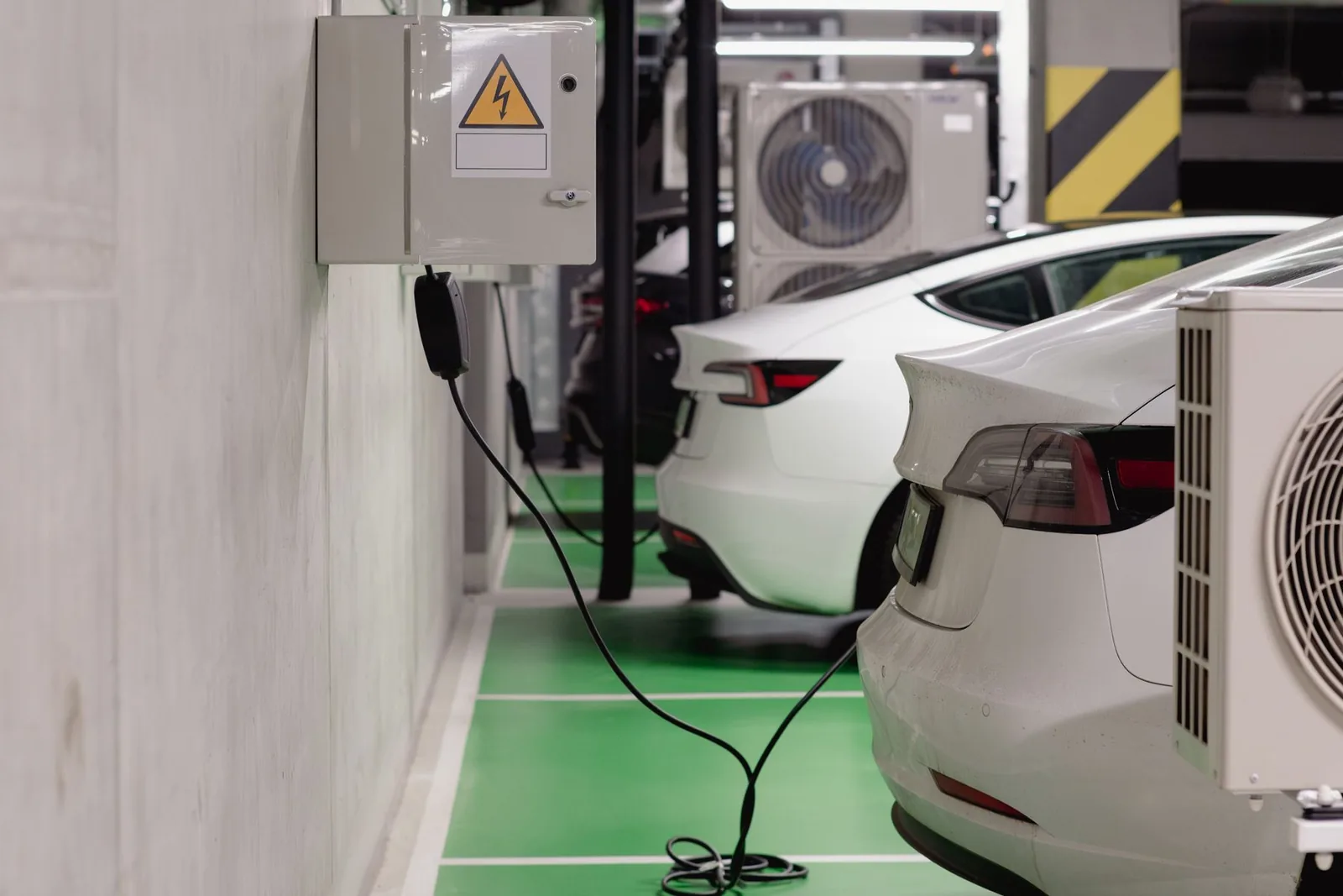 Electric cars charging inside a shared garage